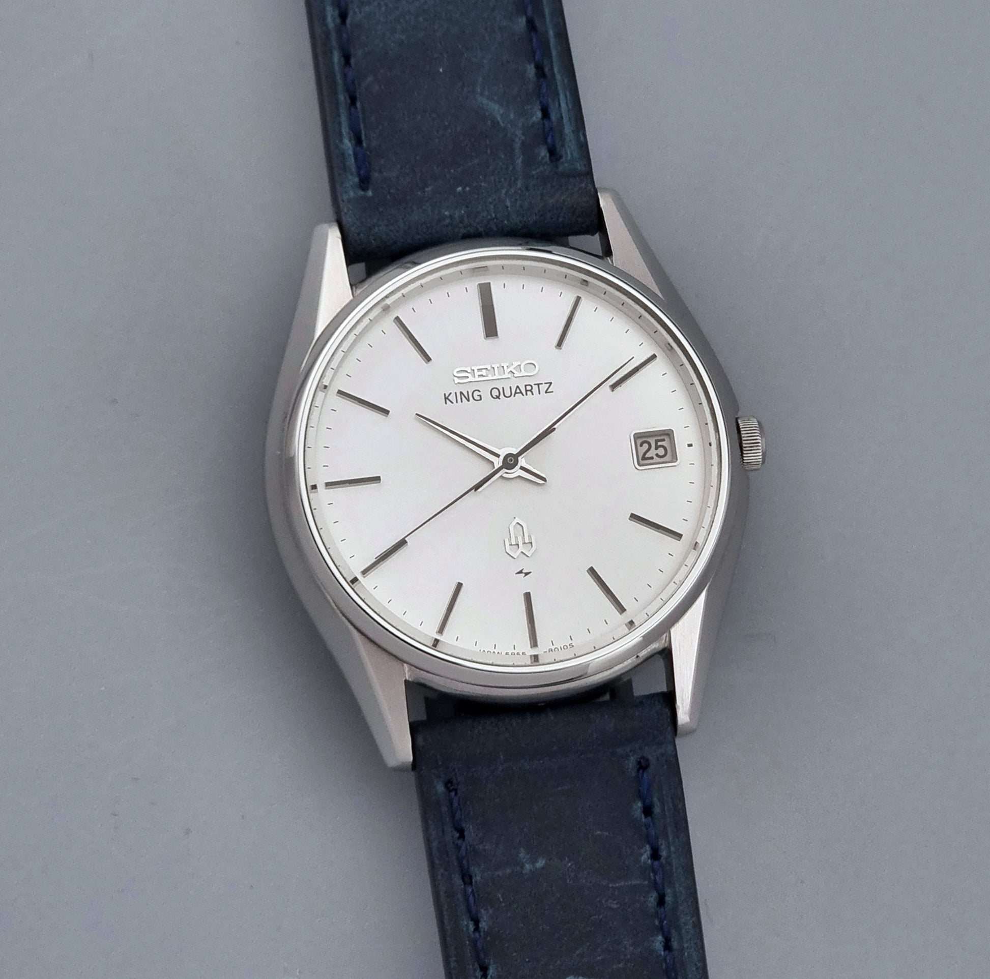 Vintage Seiko King Quartz watch 5855-8010 with blue leather strap on a gray background front view