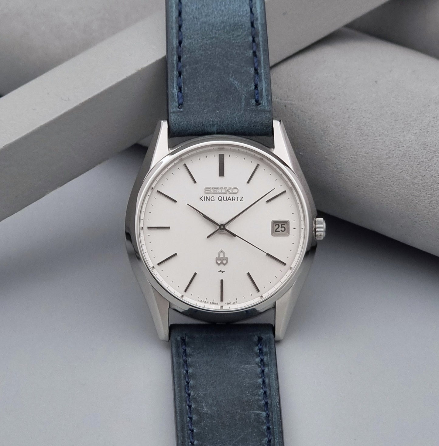 Vintage Seiko King Quartz watch 5855-8010 with blue leather strap on a gray background dial view