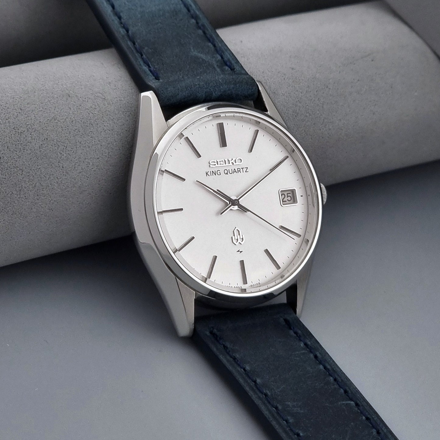 Vintage Seiko King Quartz watch 5855-8010 with blue leather strap on a gray background side view