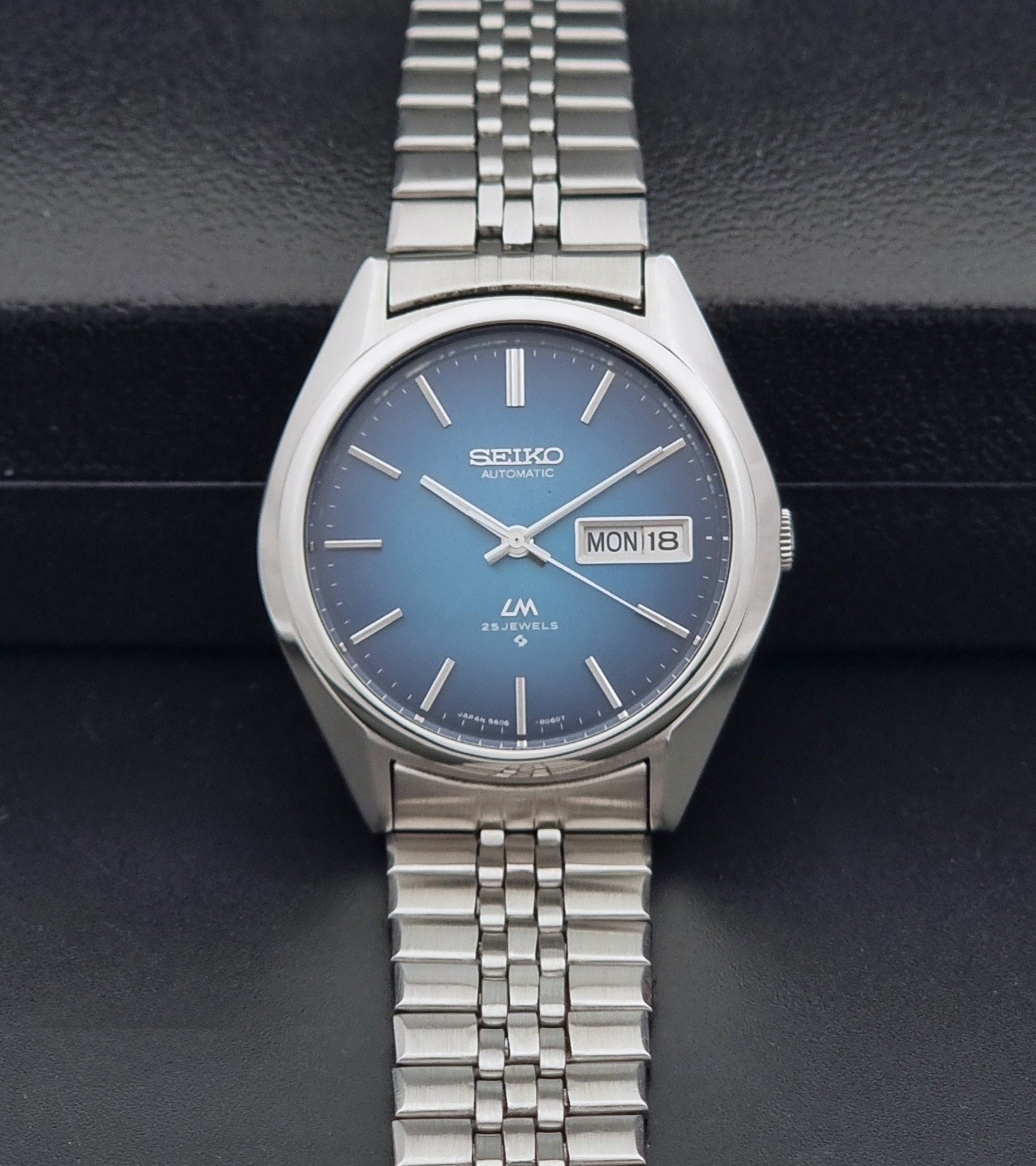 Vintage Seiko LordMatic 5606-8030 Wristwatch with blue dial on dark background dial view