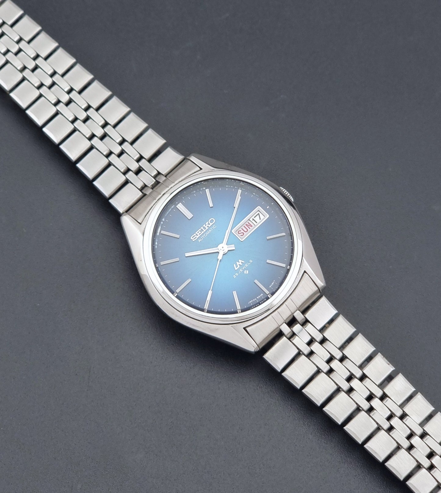 Vintage Seiko LordMatic 5606-8030 Wristwatch with blue dial on dark background dial