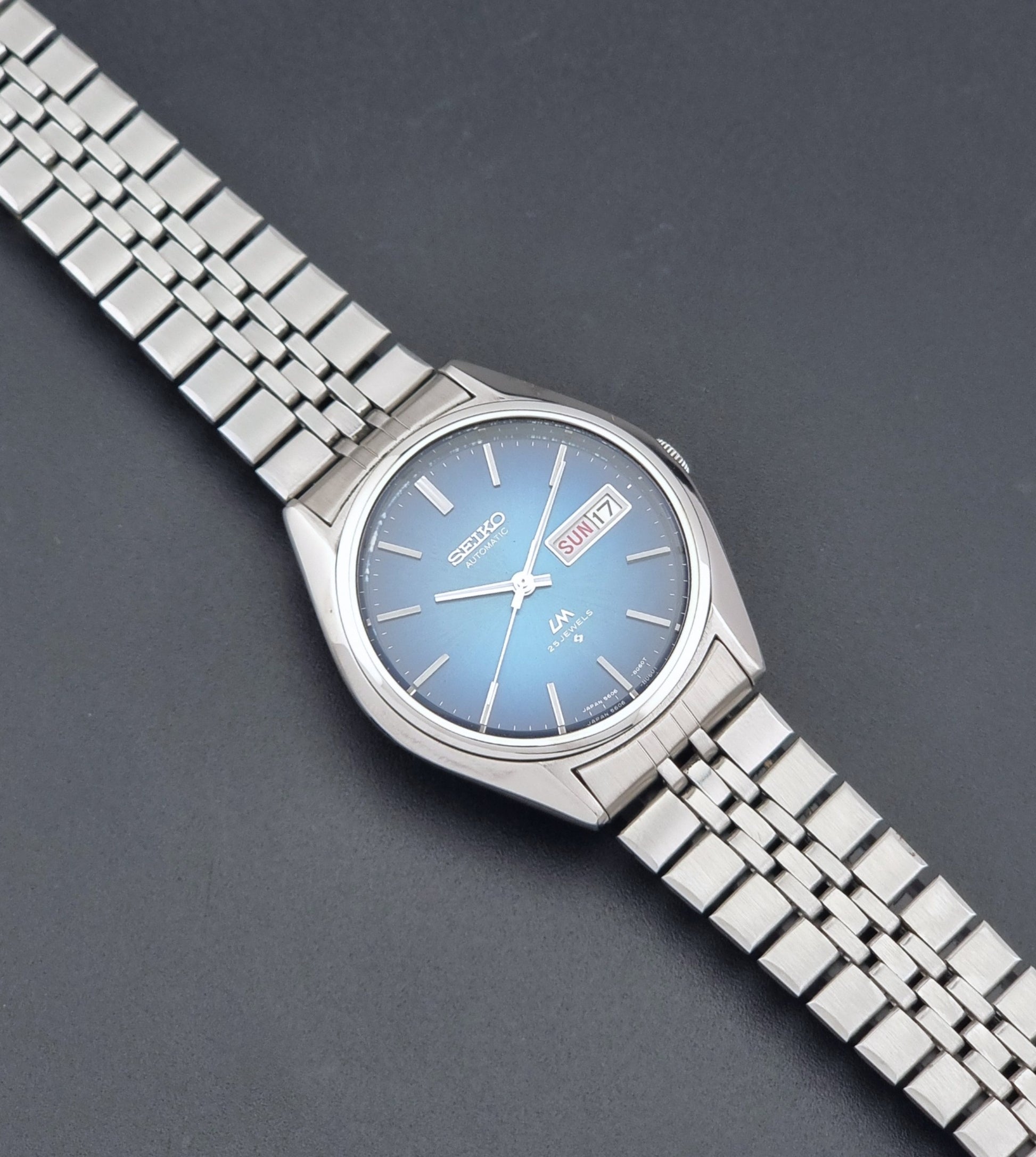 Vintage Seiko LordMatic 5606-8030 Wristwatch with blue dial on dark background dial