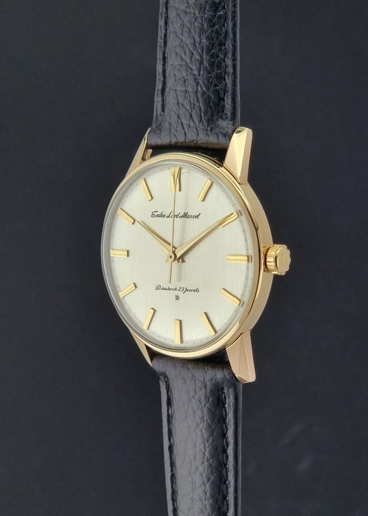 Vintage Seiko watch Lord Marvel 15023E gold filled on a dark background crown profile view