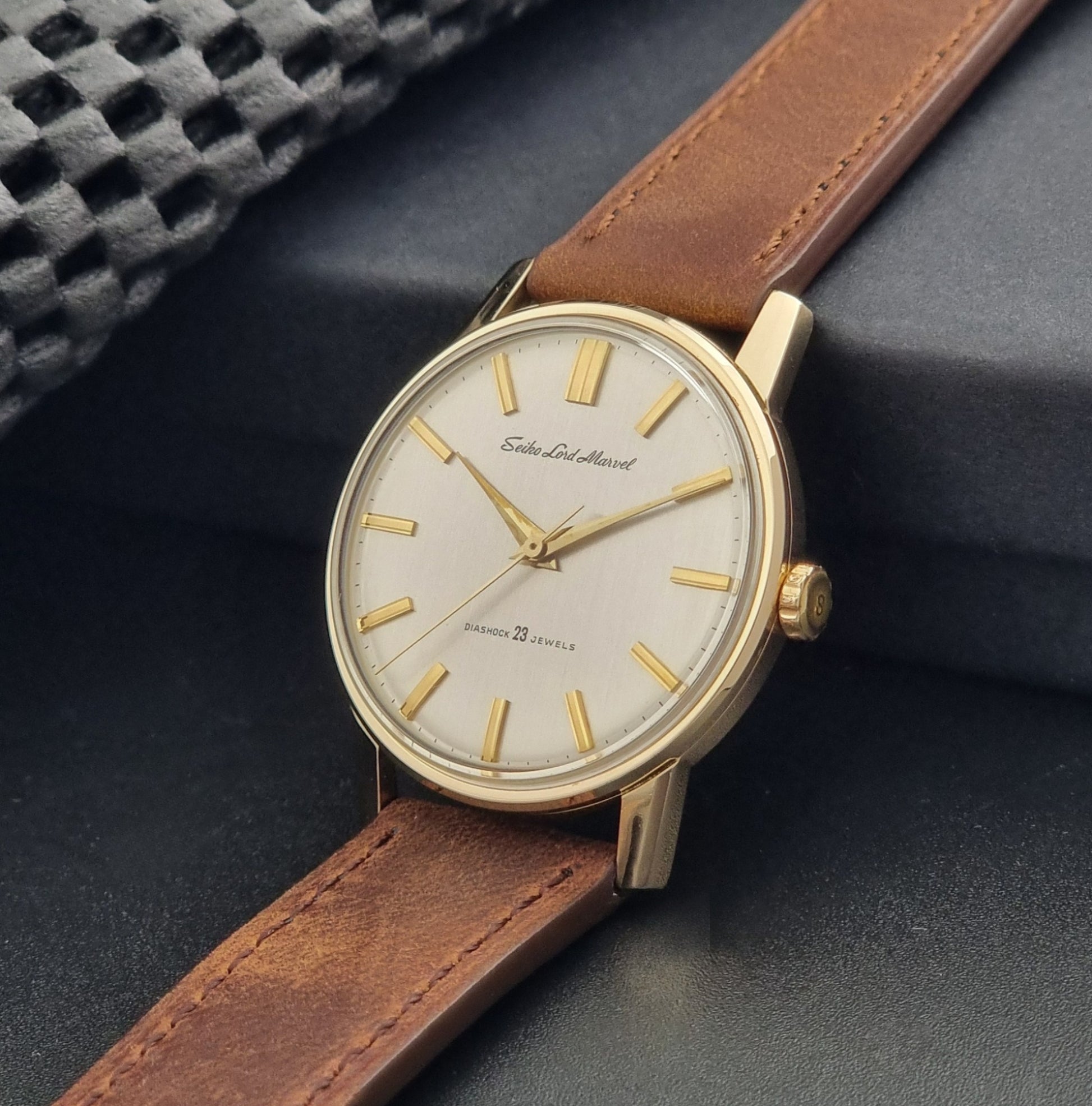 Vintage Seiko Lord Marvel 5740-1991 gold filled watch on a dark background crown view