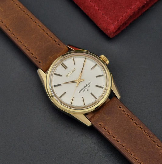 Vintage Seiko watch Lord Marvel 5740-8000 with brown leather strap and gold case on a dark background