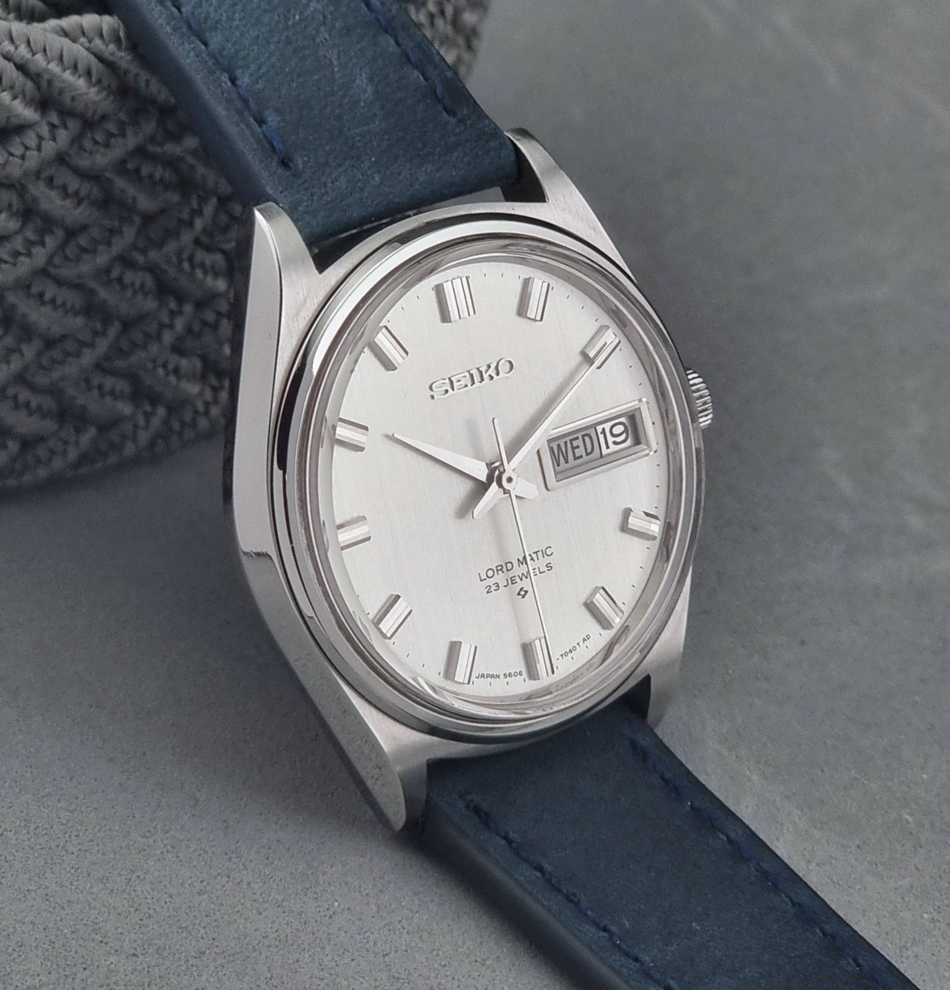 Vintage Seiko  watch with blue strap on a gray background