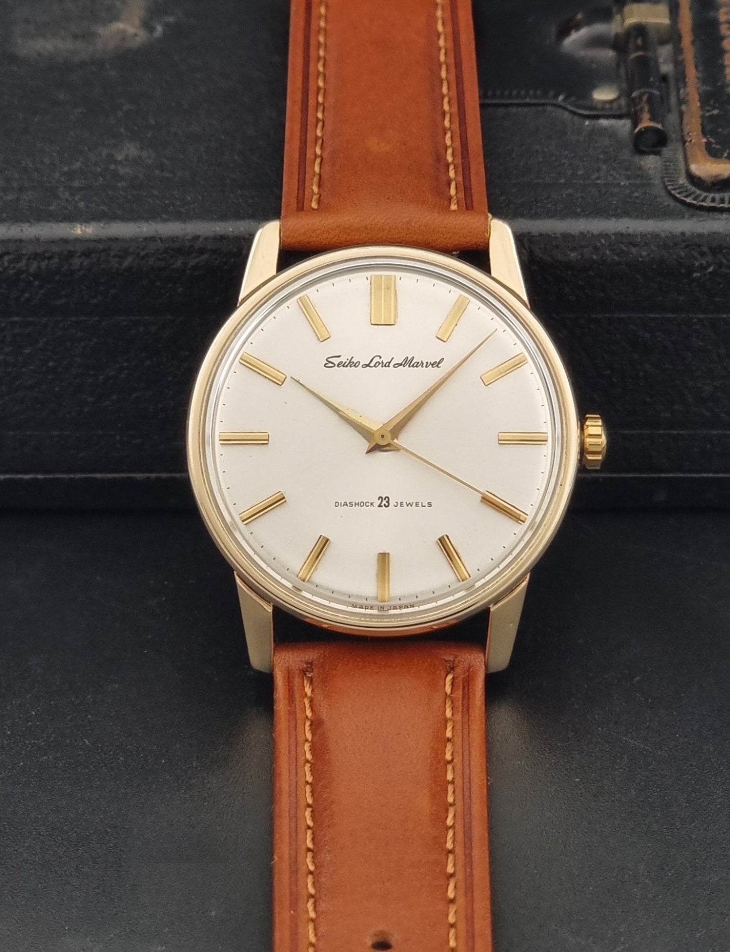 Vintage Seiko Lordmarvel Wristwatch 5740-1990 with a gold filled case and brown leather strap on a dark background dial view