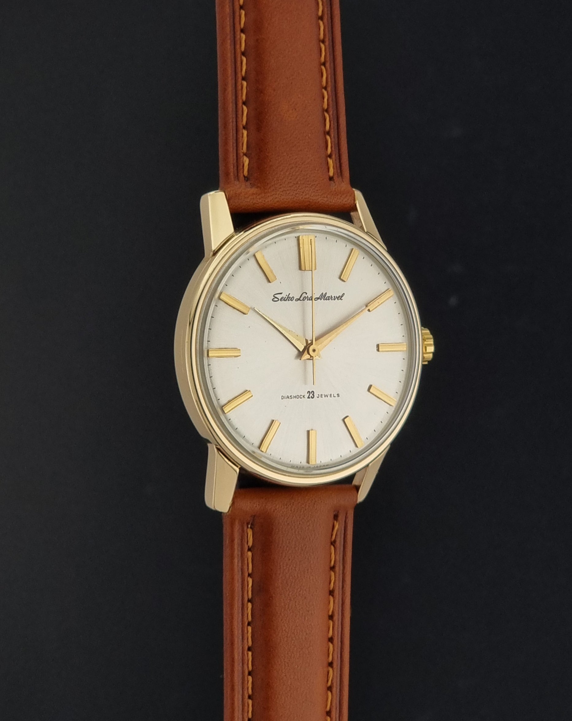 Vintage Seiko Lordmarvel Wristwatch 5740-1990 with a gold filled case and brown leather strap on a dark background side profile view