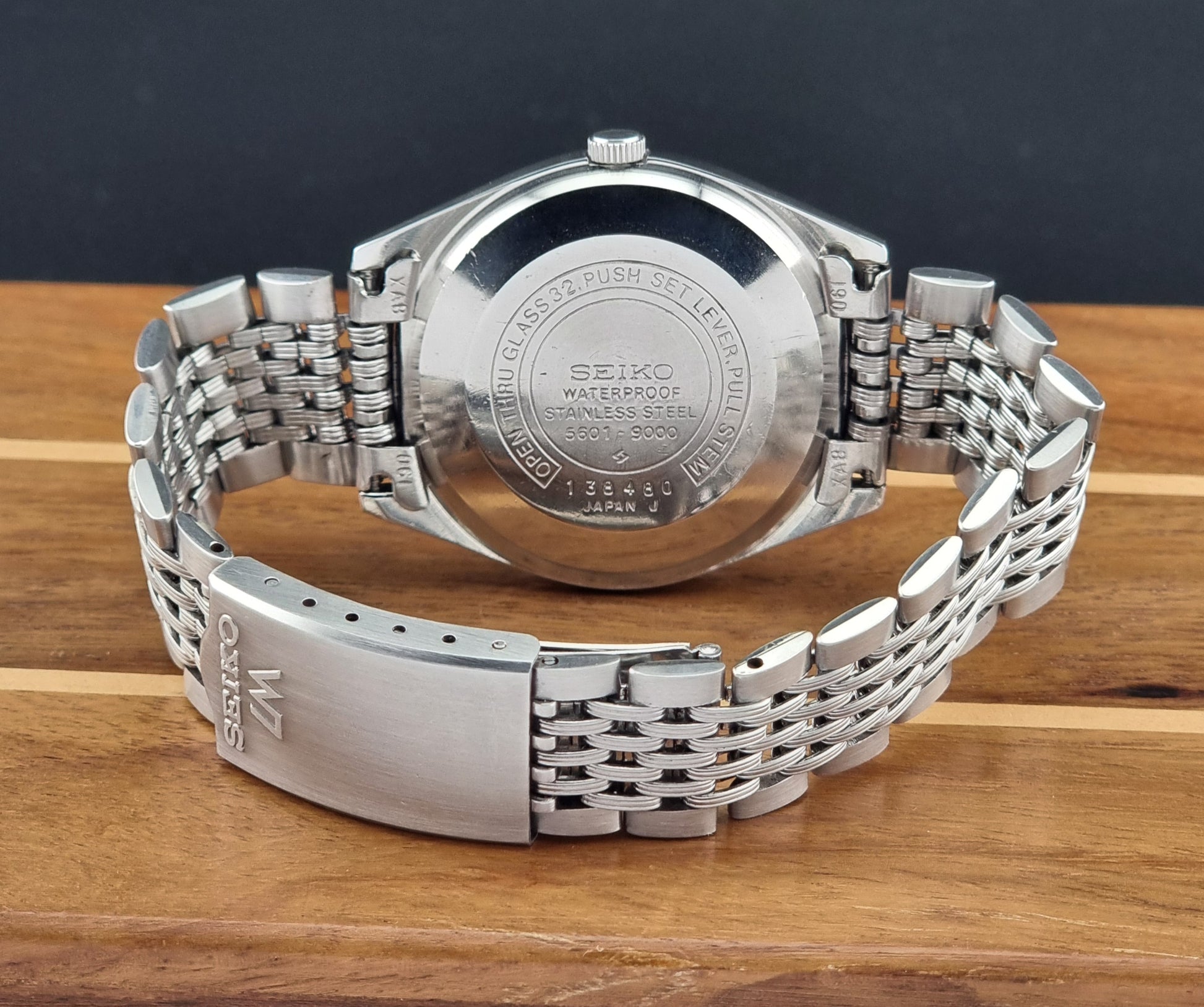 Vintage Seiko watch LordMatic 5601-9000 back view and a metal bracelet