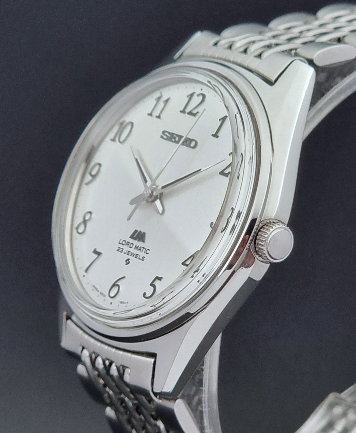 Vintage Seiko watch LordMatic 5601-9000  on a dark background crown side profile