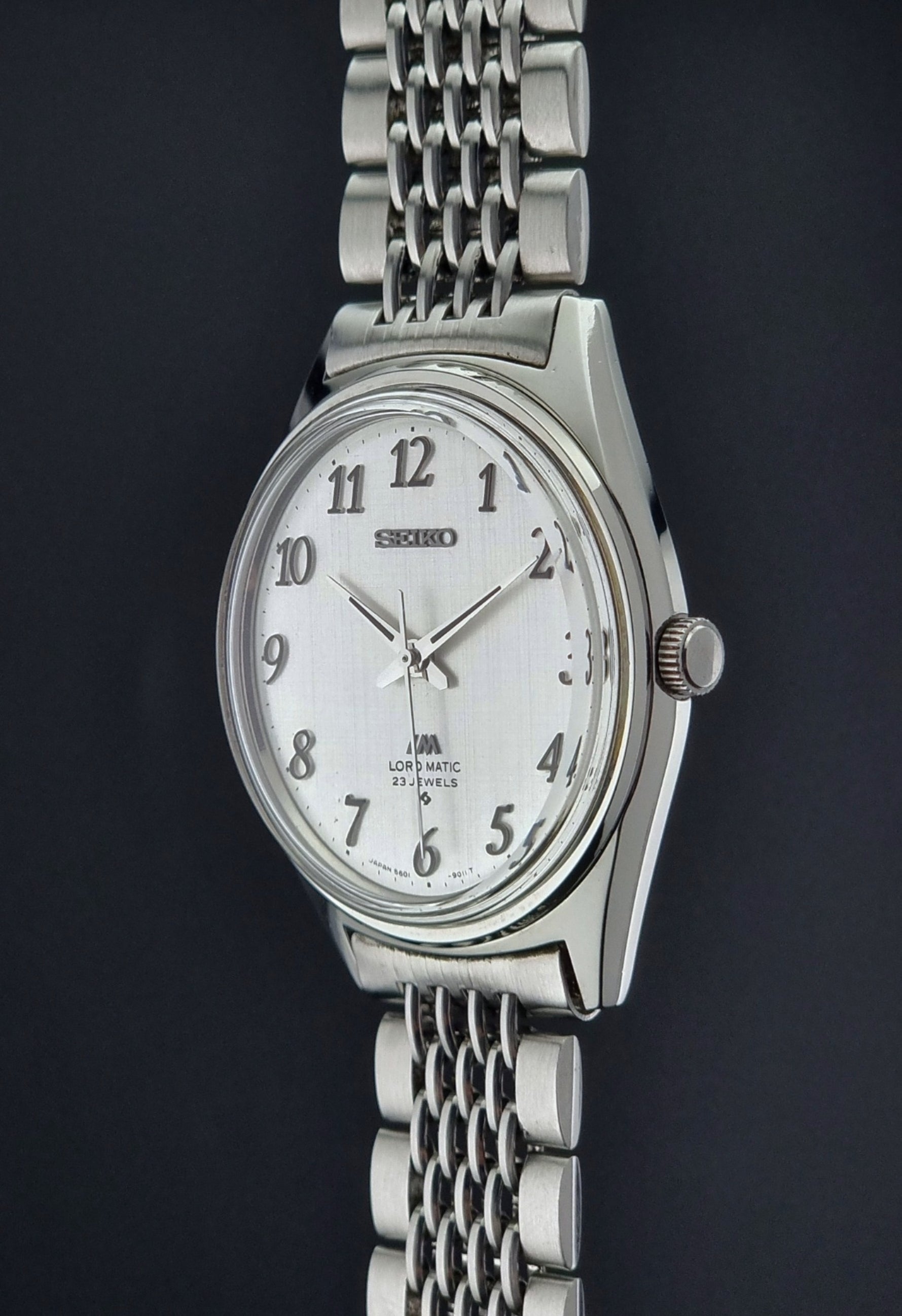 Silver Seiko Lord Matic watch with a white face on a dark background