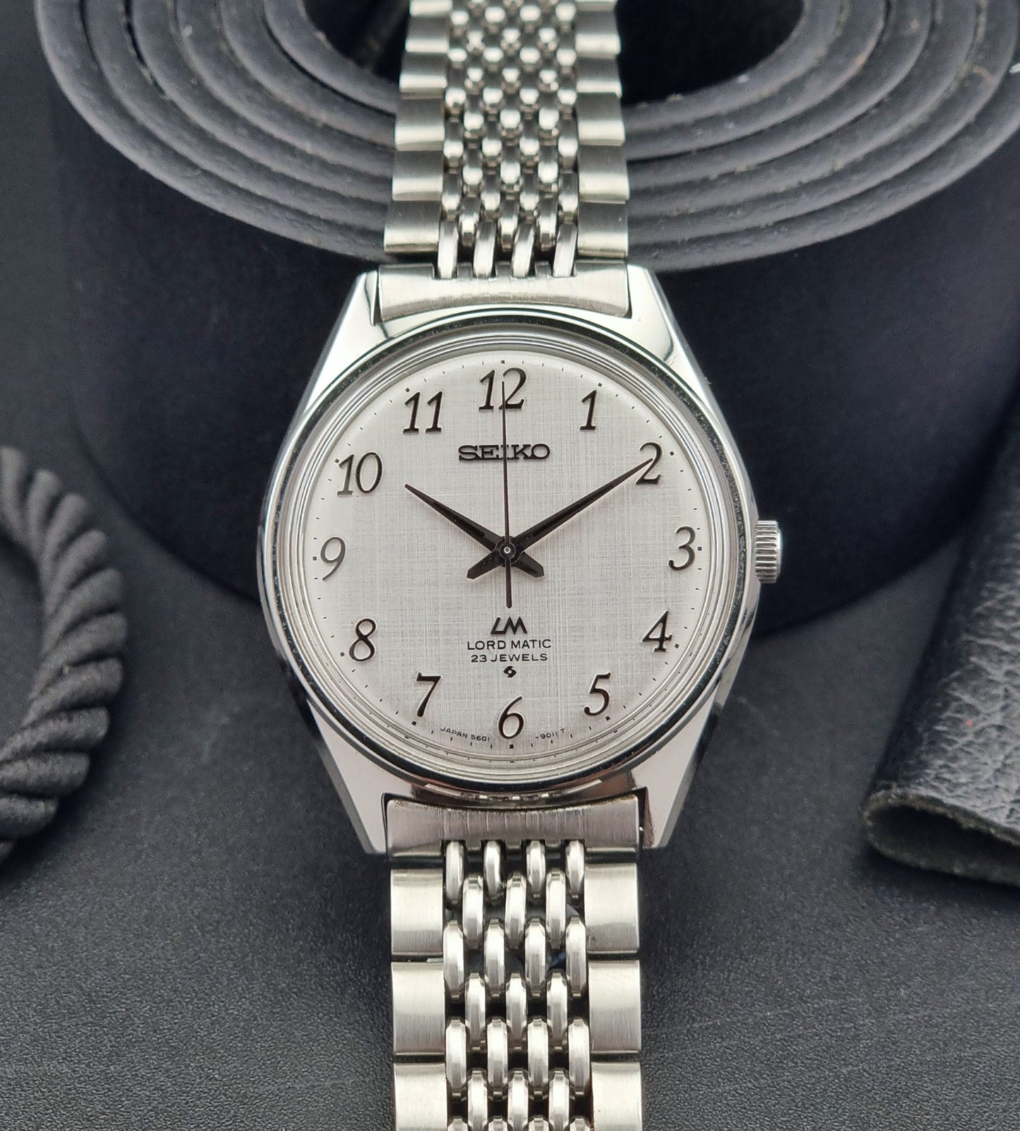 Seiko Lord Matic watch with a detailed face on a dark textured background