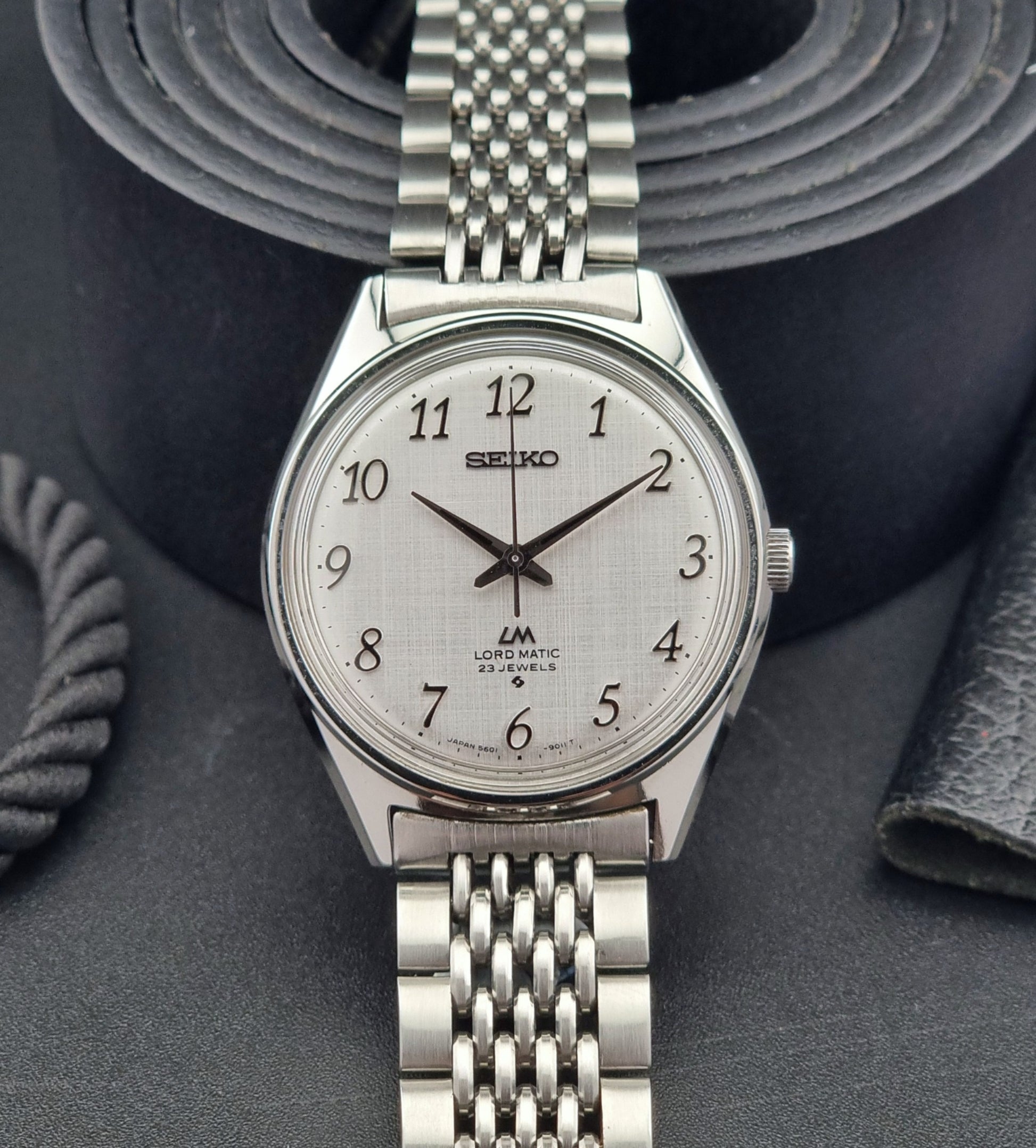 Seiko Lord Matic watch with a detailed face on a dark textured background