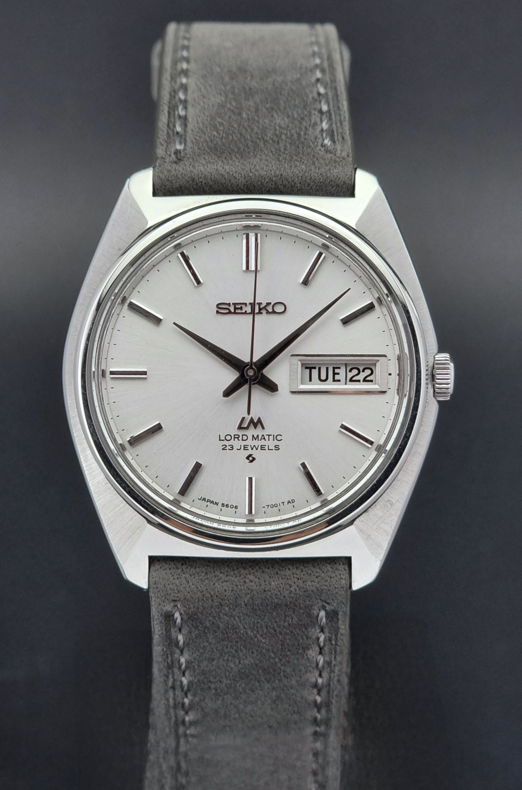 Vintage Seiko Wristwatch LordMatic 5606-7000with gray strap on a dark background