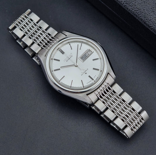 Vintage Seiko Wristwatch 5606-7071  with a metallic band on a dark background dial