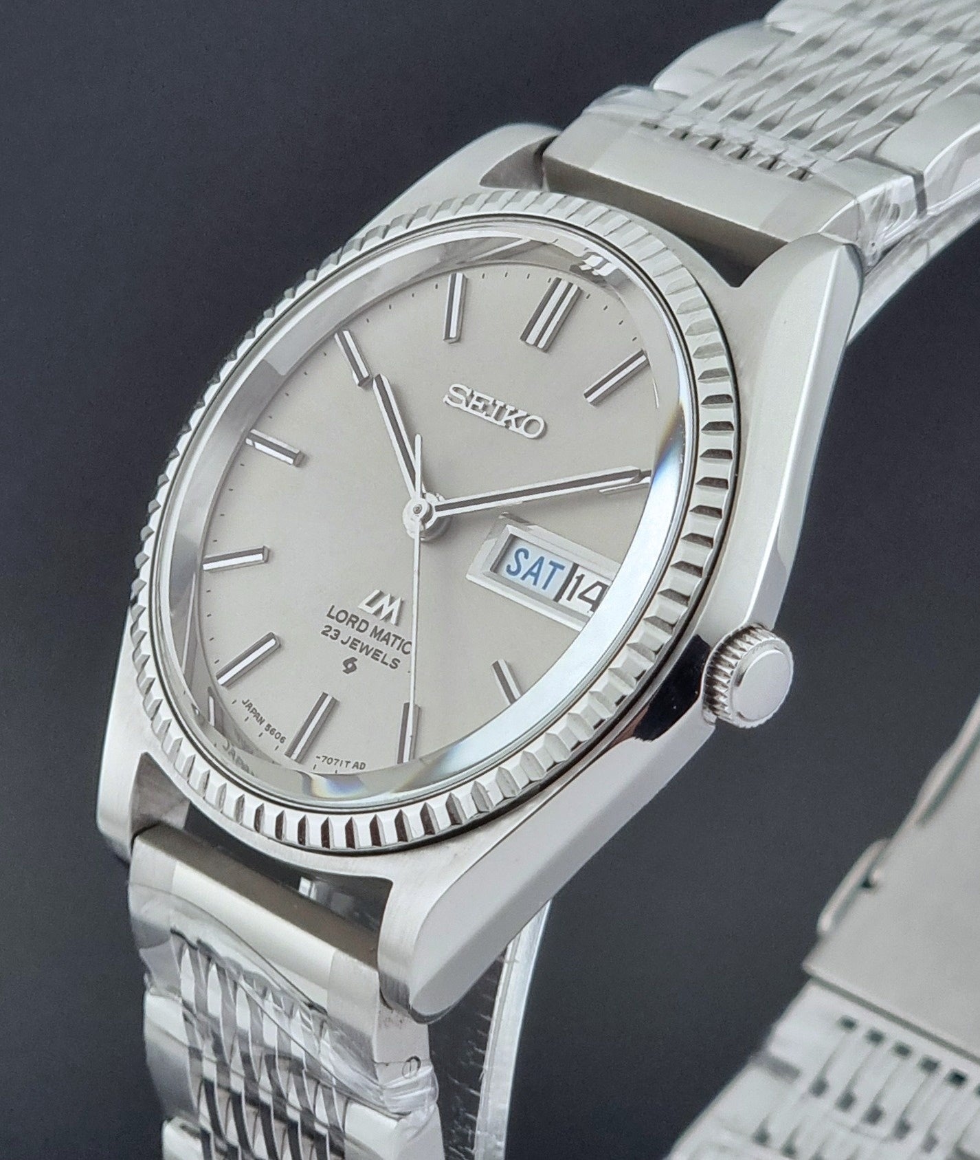 Seiko Wristwatch LordMatic 5606-7080  on a dark textured surface close up crown side profile