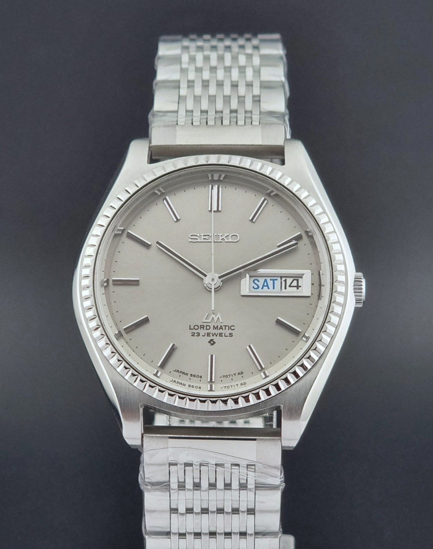 Seiko Wristwatch LordMatic 5606-7080  on a dark textured surface front view