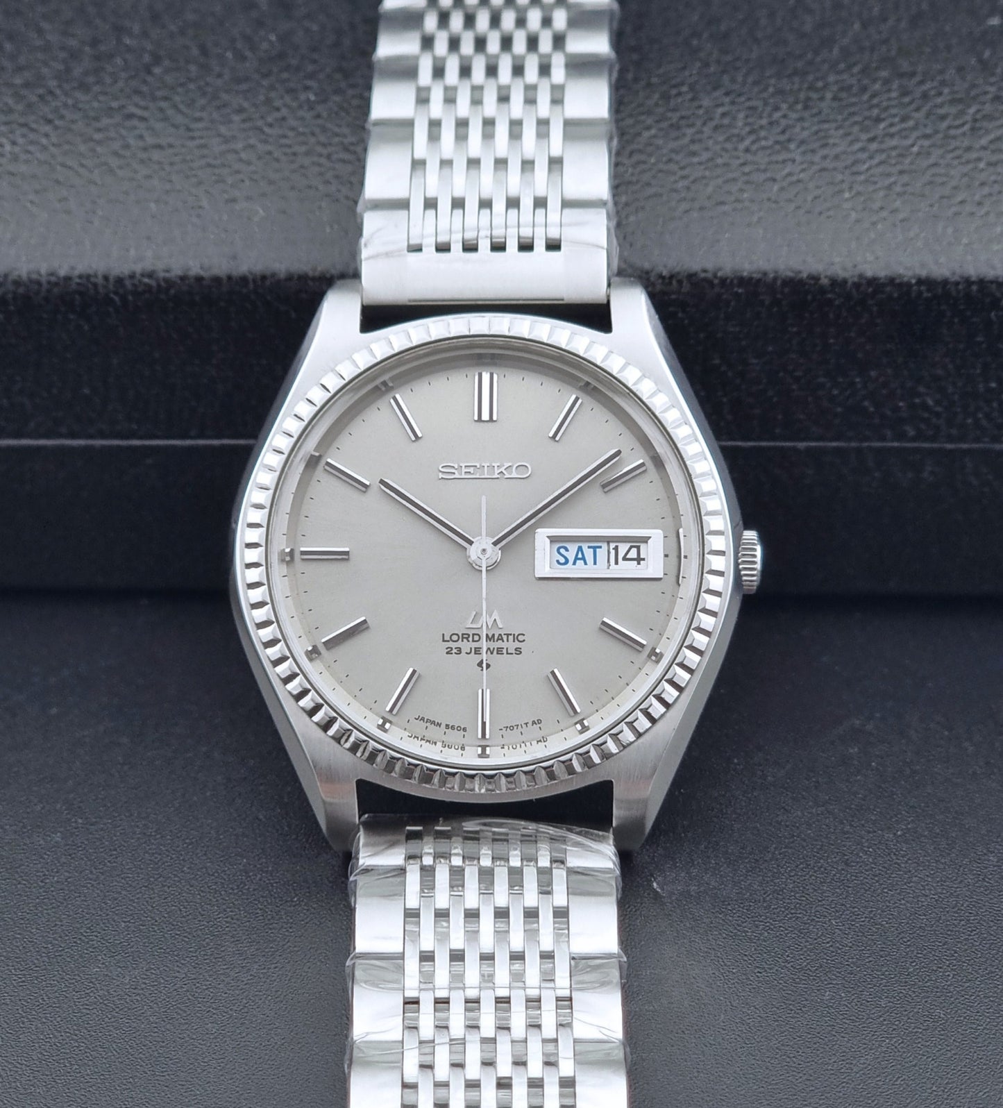 Seiko Wristwatch LordMatic 5606-7080  on a dark textured surface front view