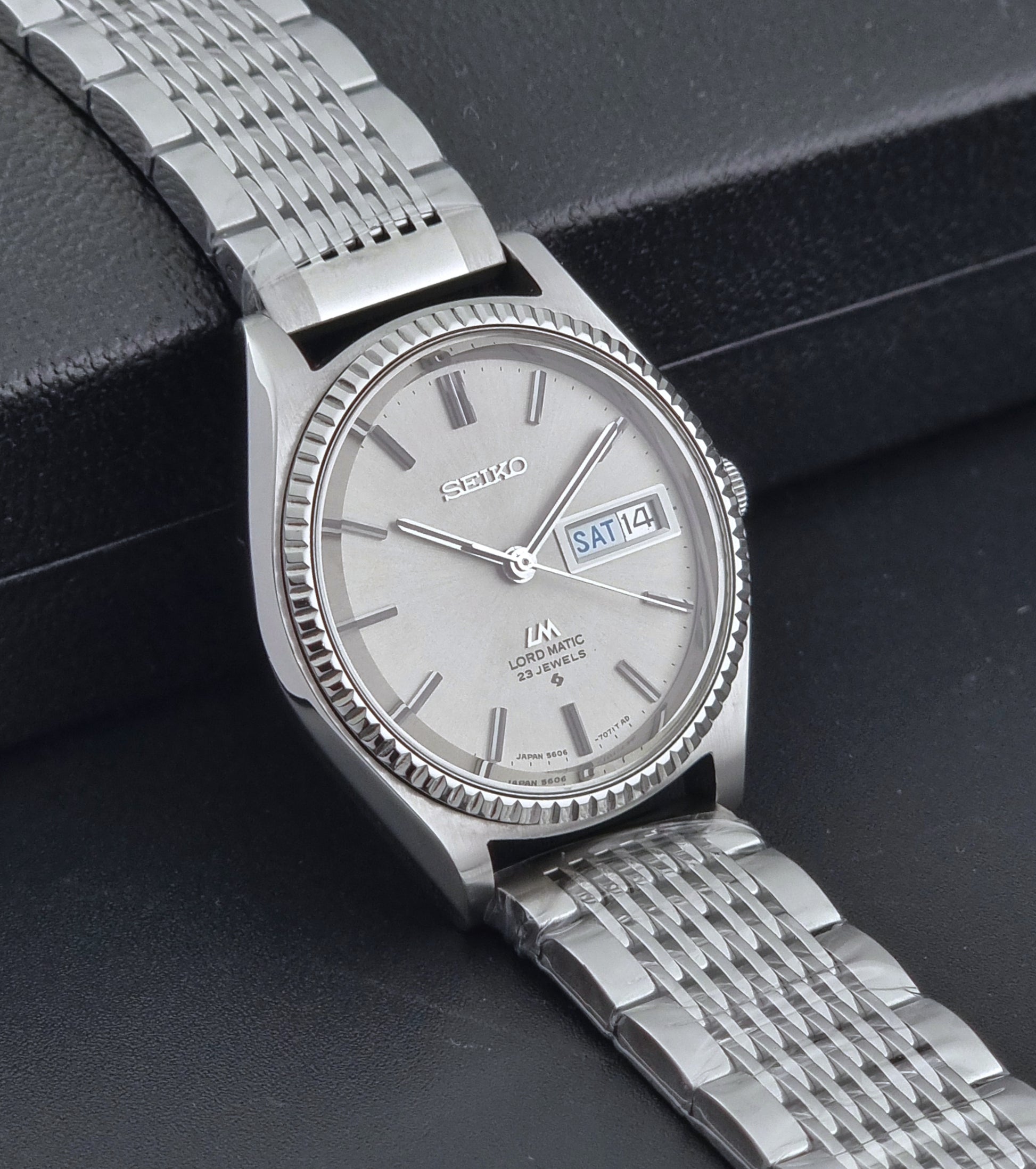 Seiko Wristwatch LordMatic 5606-7080  on a dark textured surface side view