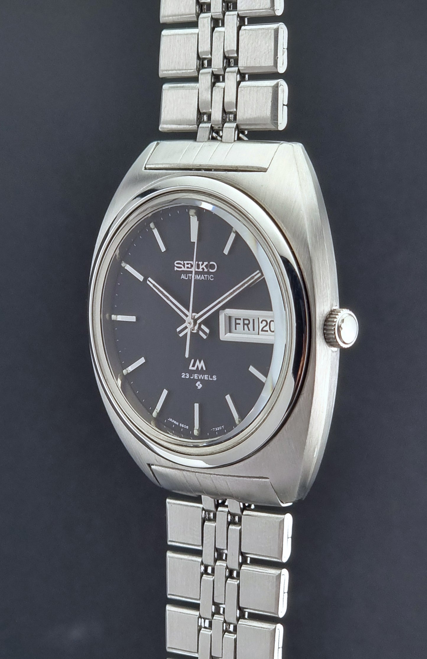 Vintage Seiko Lordmatic 5606-7140 watch with a dark face on a black background