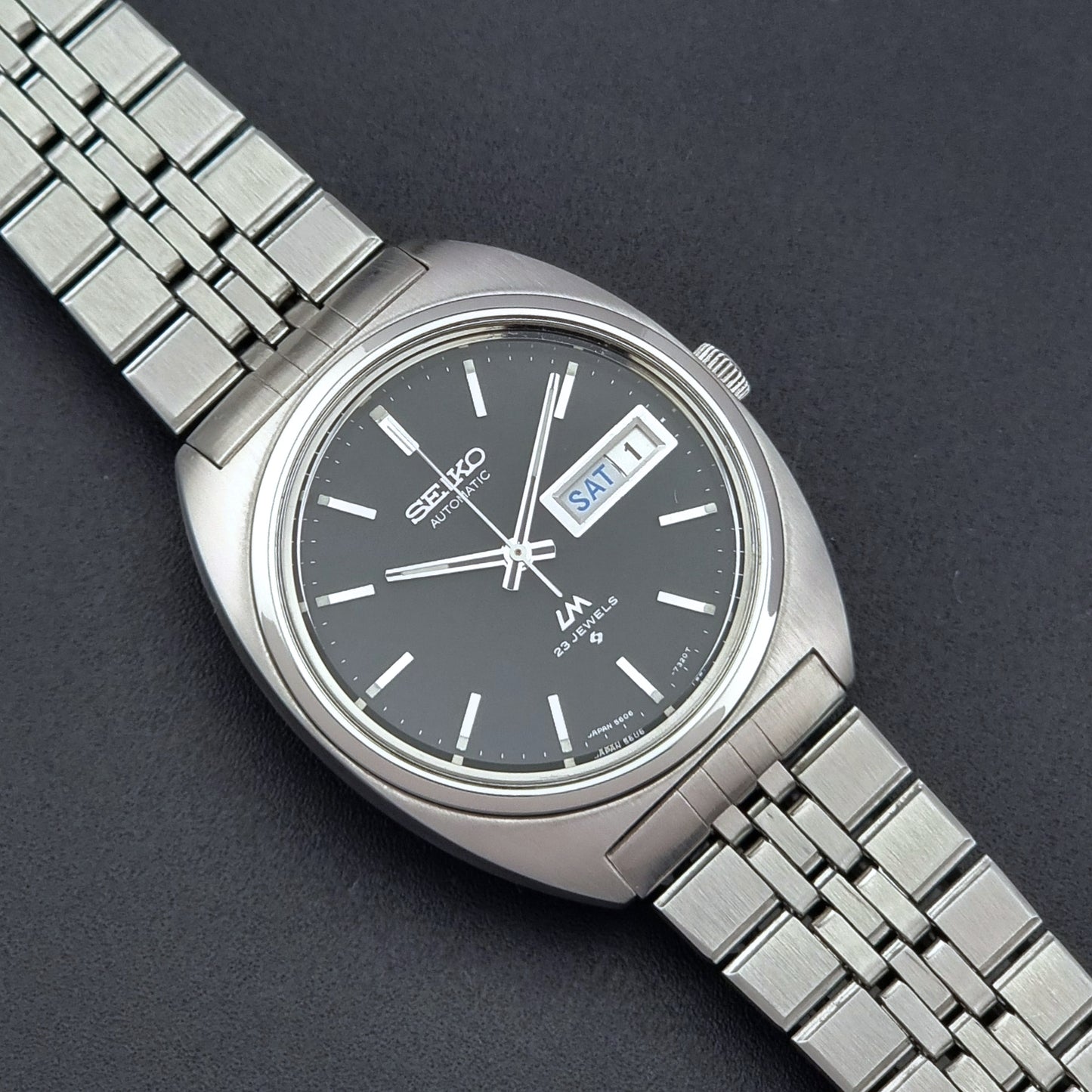 Seiko Wristwatch LordMatic 5606-7140 Vintage watch with a black face on a dark background close up dial view