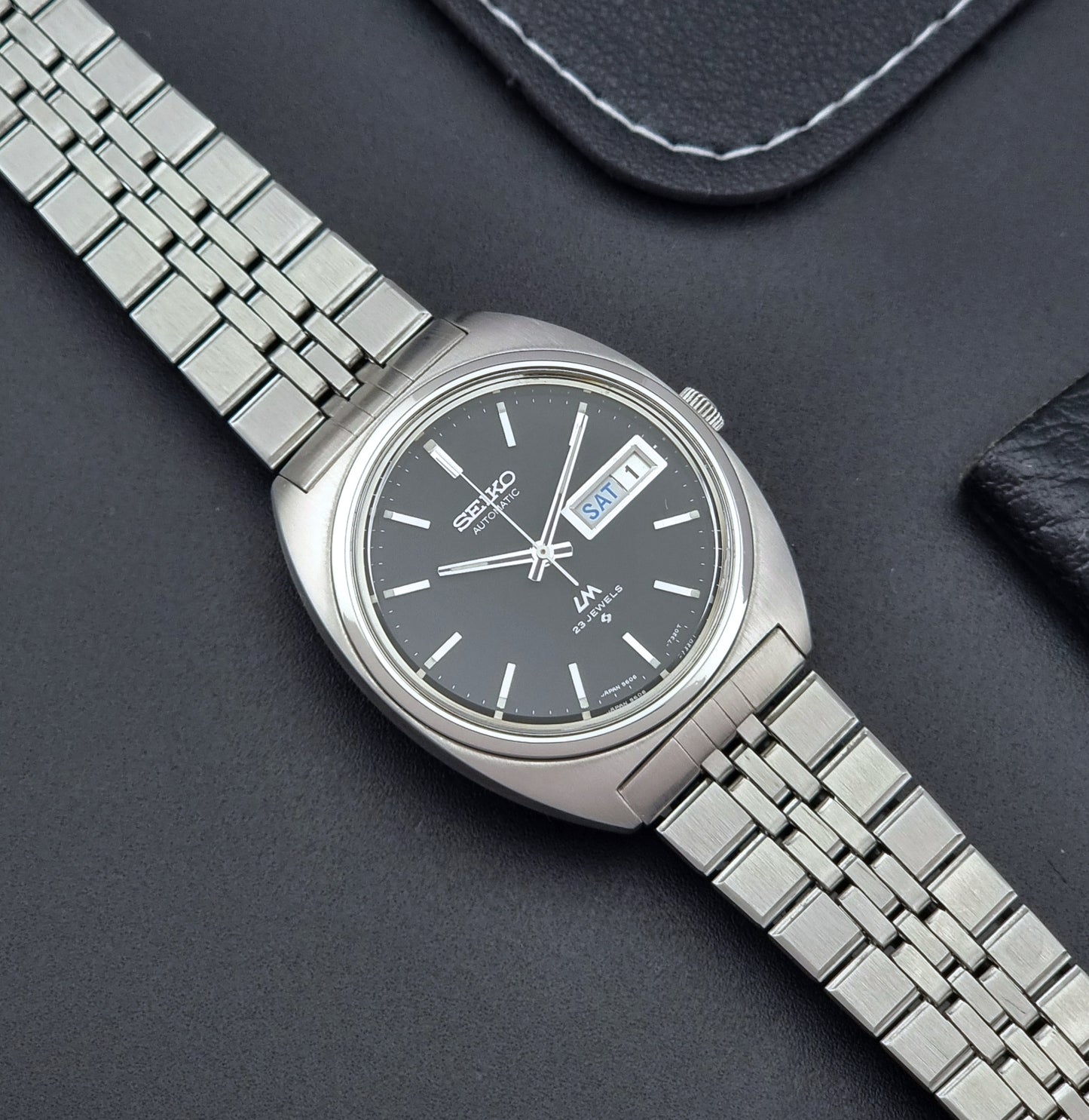 Seiko Wristwatch LordMatic 5606-7140 Vintage watch with a black face on a dark background dial