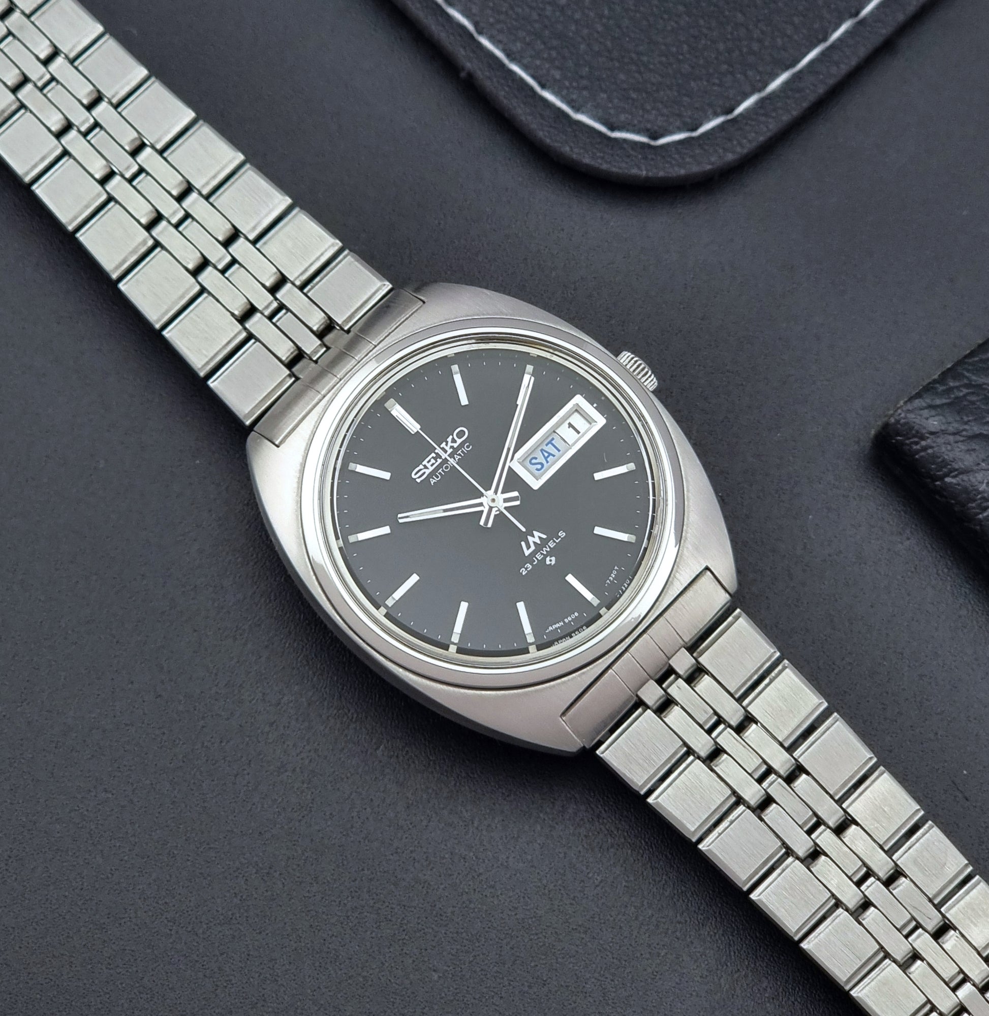 Seiko Wristwatch LordMatic 5606-7140 Vintage watch with a black face on a dark background dial
