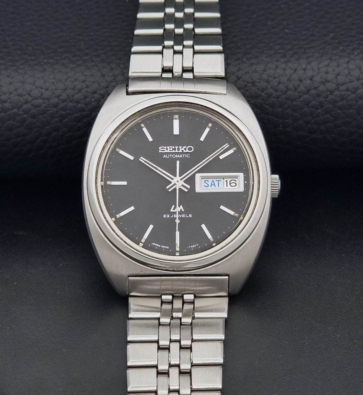 Vintage Seiko Wristwatch LordMatic 5606-7140 with  stainless steel bracelet on a dark background dial view