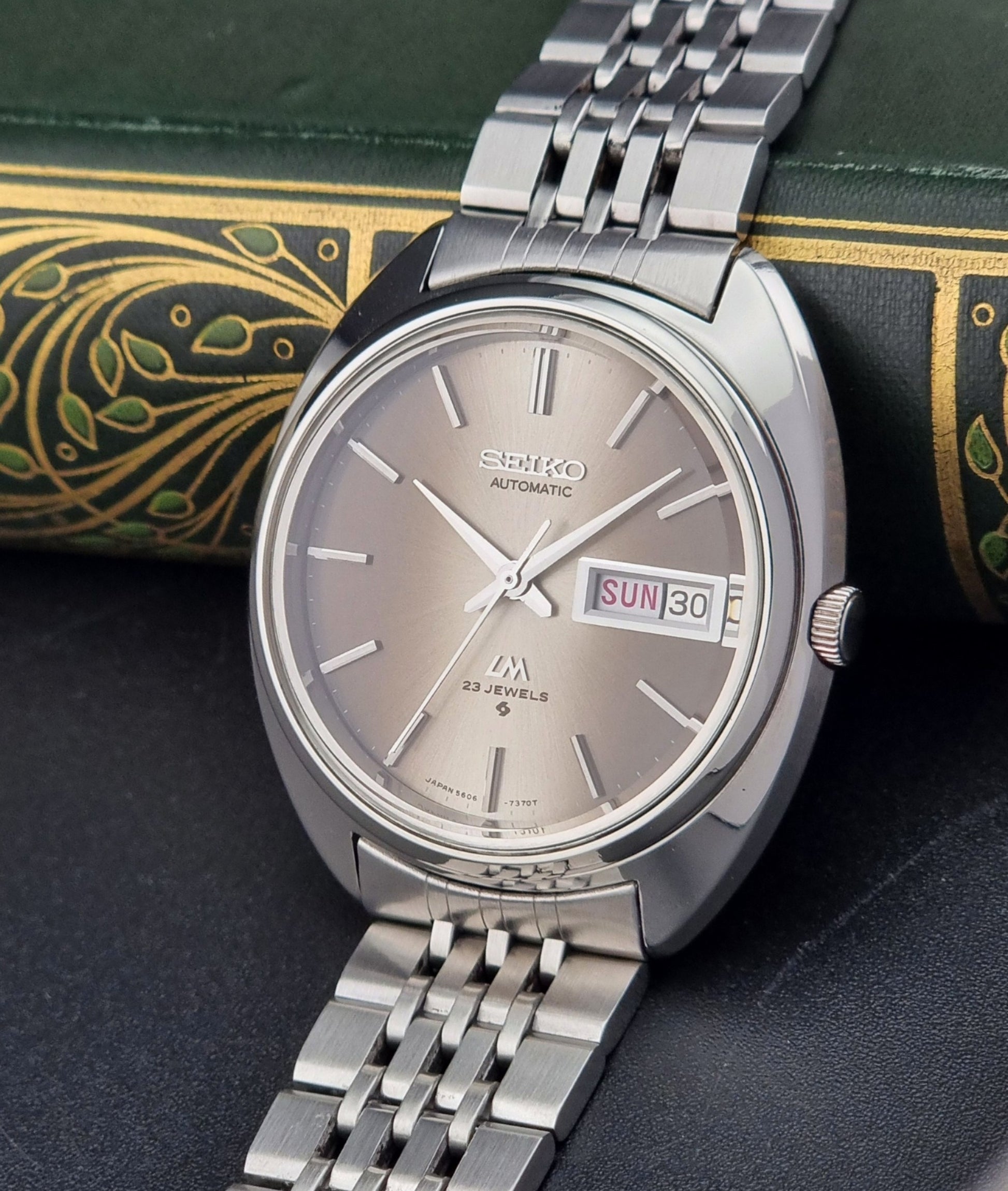 Silver Vintage Seiko Lord Matic watch with a detailed background