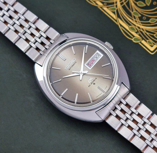 Silver Vintage Seiko Lord Matic watch with a detailed background