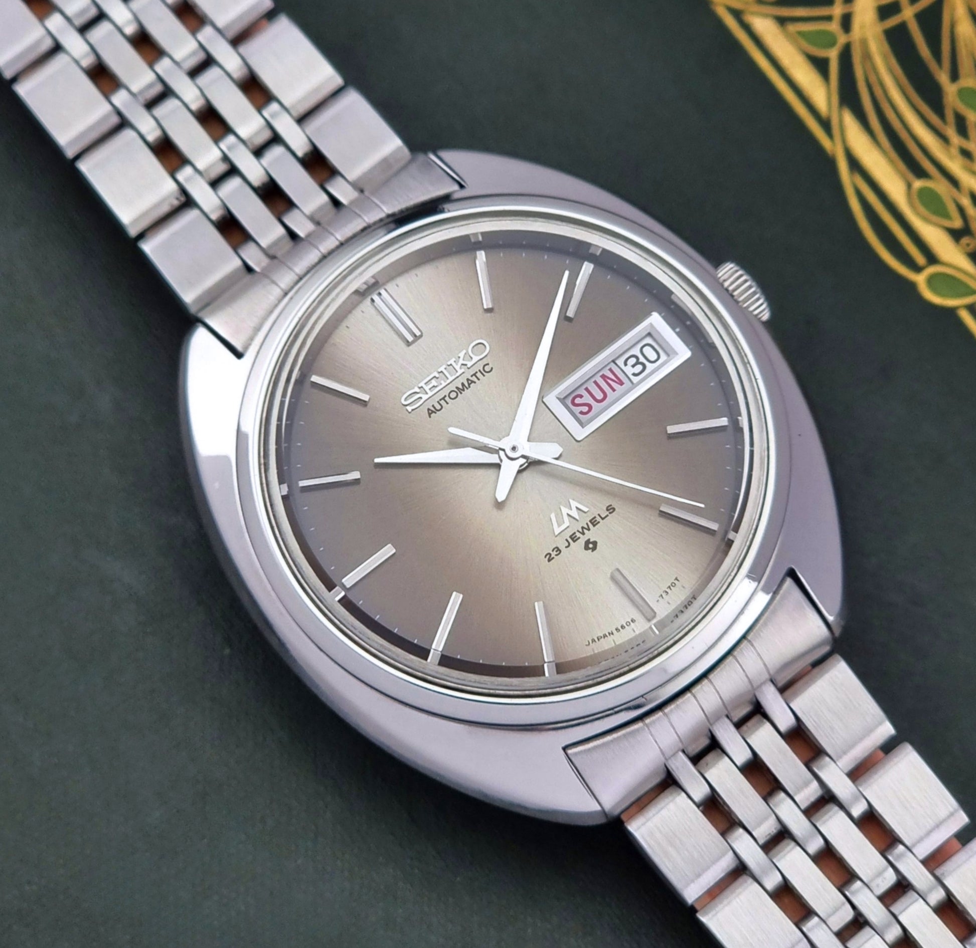 Silver Vintage Seiko Lord Matic watch with a detailed face on a dark background