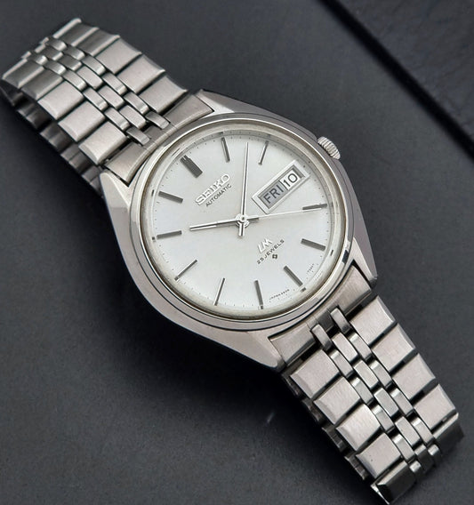 Vintage Seiko Wristwatch LordMatic 5606-7190 watch with a metal bracelet on a dark background dial