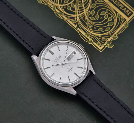 Vintage Seiko watch LordMatic 5606-8050 with a white dial on a dark surface front