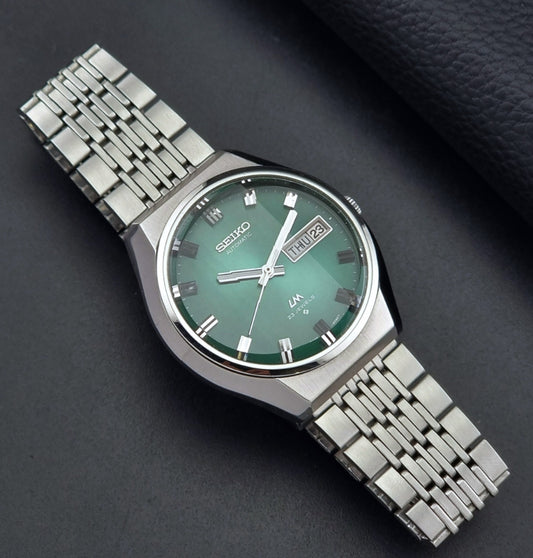 Vintage Seiko watch LordMatic 5606-8060 with green face on a dark background dial