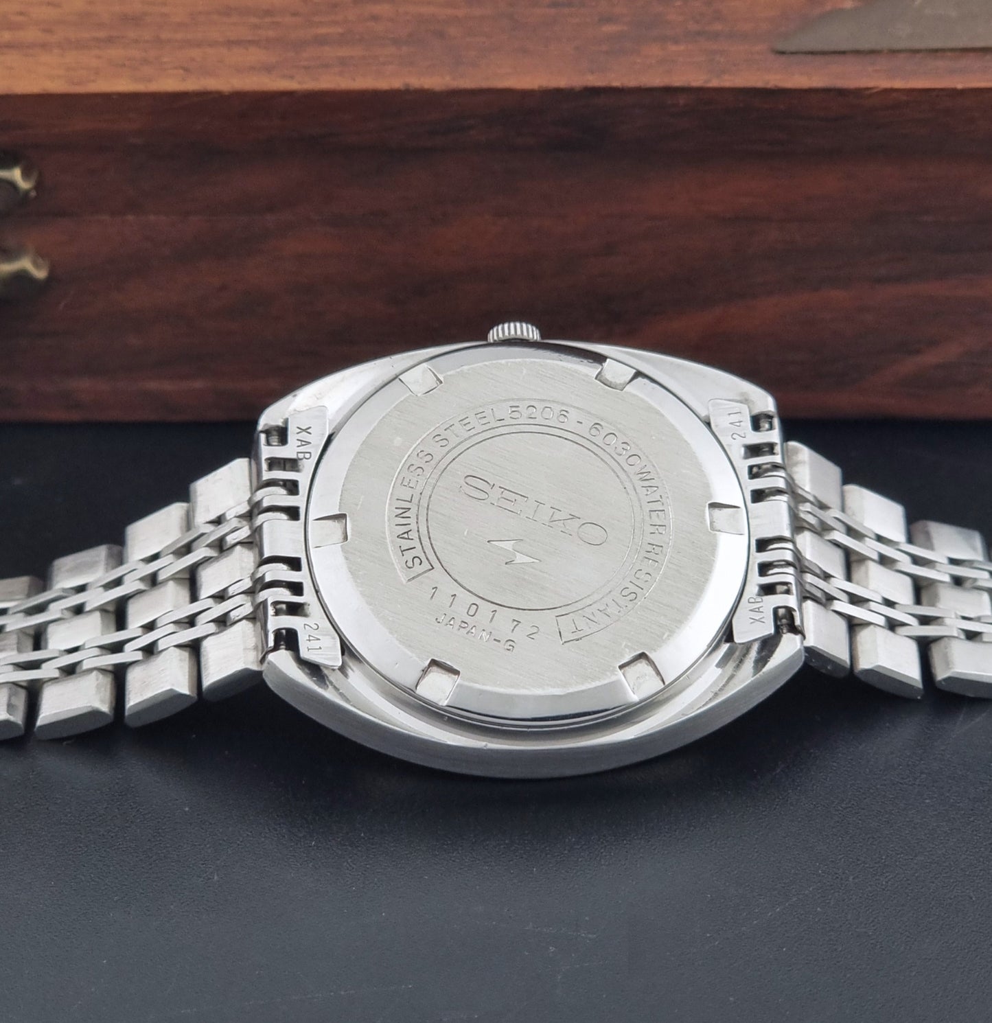 Vintage Seiko watch LordMatic Special 5206-6030 with a stainless steel bracelet on a dark background back view