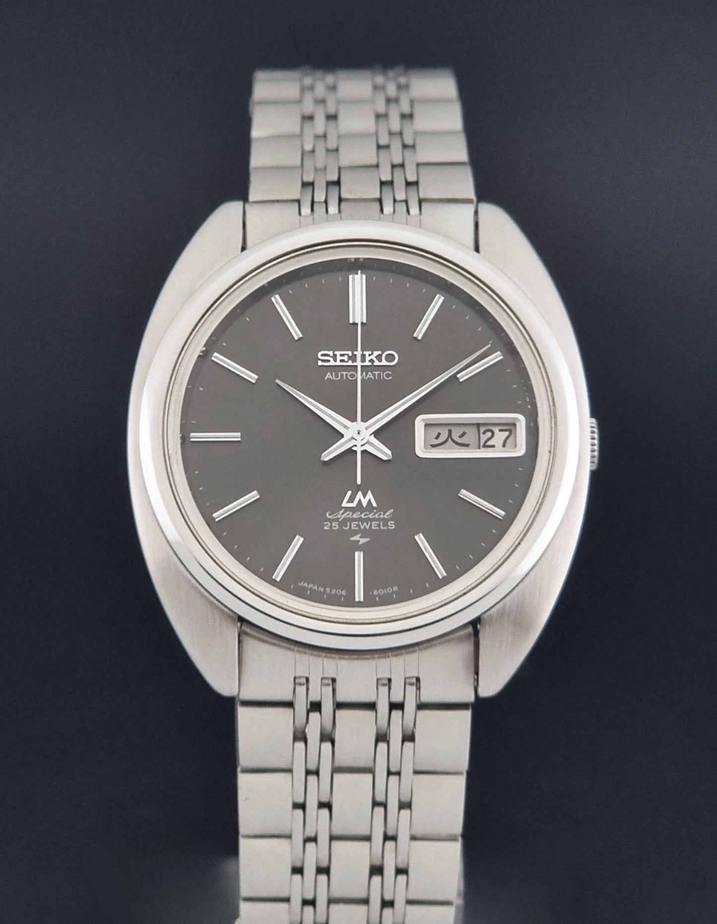Vintage Seiko watch LordMatic Special 5206-6030 with a stainless steel bracelet on a dark background close dial view