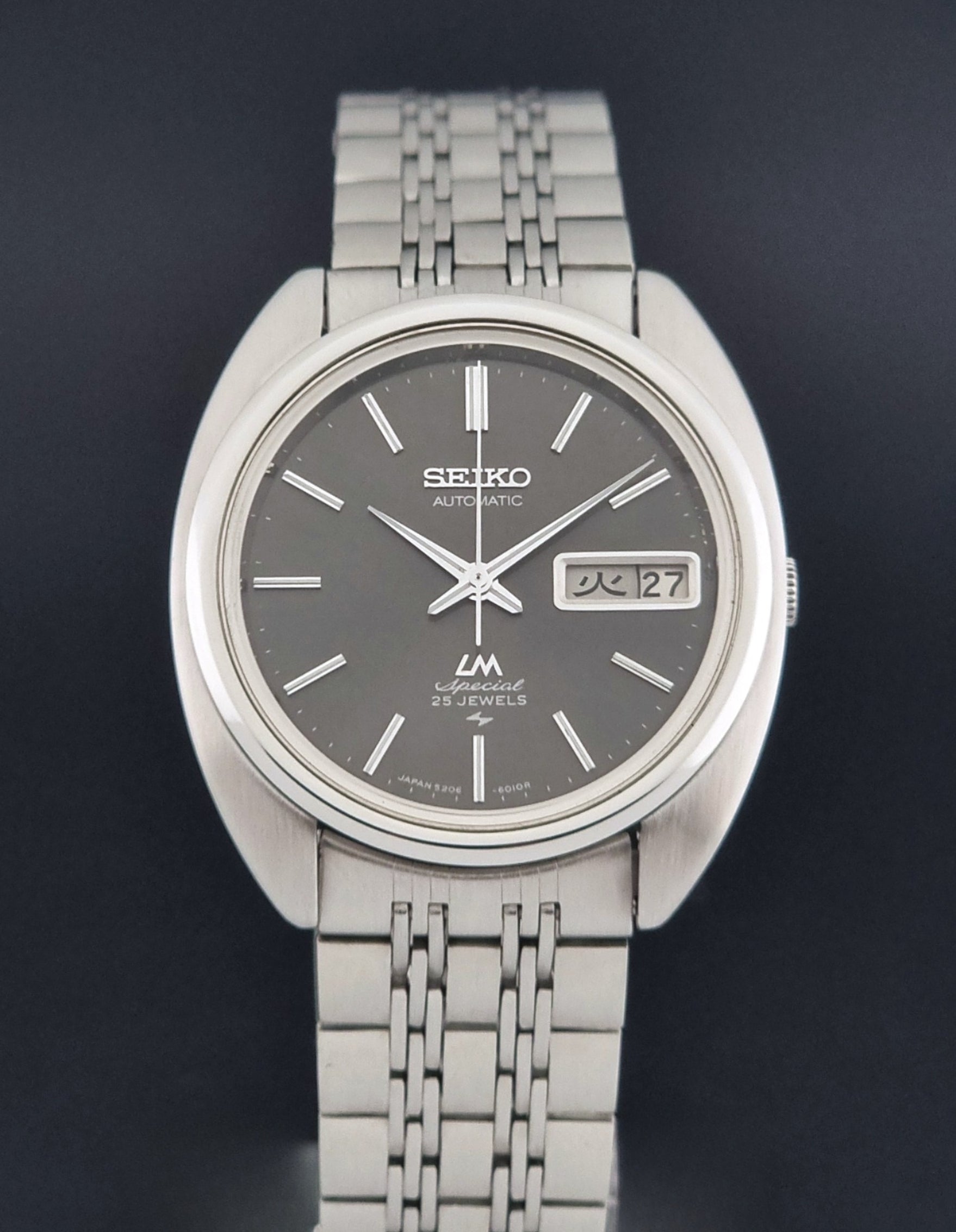 Vintage Seiko watch LordMatic Special 5206-6030 with a stainless steel bracelet on a dark background close dial view