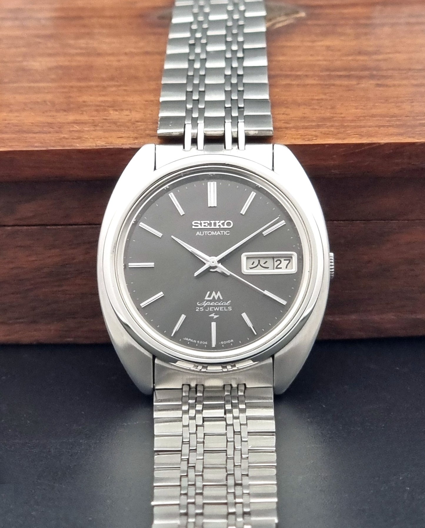 Vintage Seiko watch LordMatic Special 5206-6030 with a stainless steel bracelet on a dark background dial view