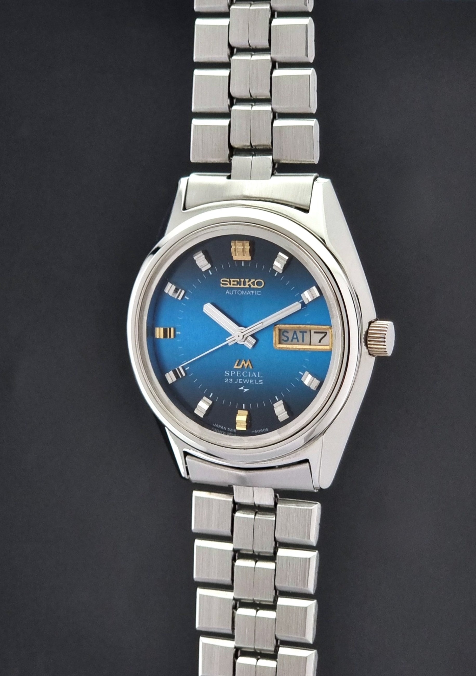 Vintage Seiko Wristwatch LordMatic Special 5216-6050 with blue dial on a dark background crown profile view