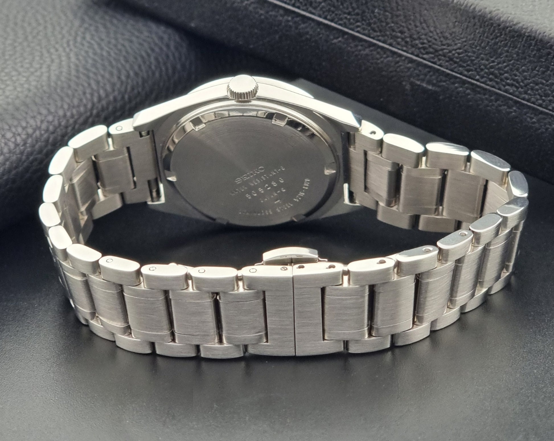 Vintage Seiko Wristwatch LordMatic Special 5216-8020 with a brown dial on a dark gray background case back view