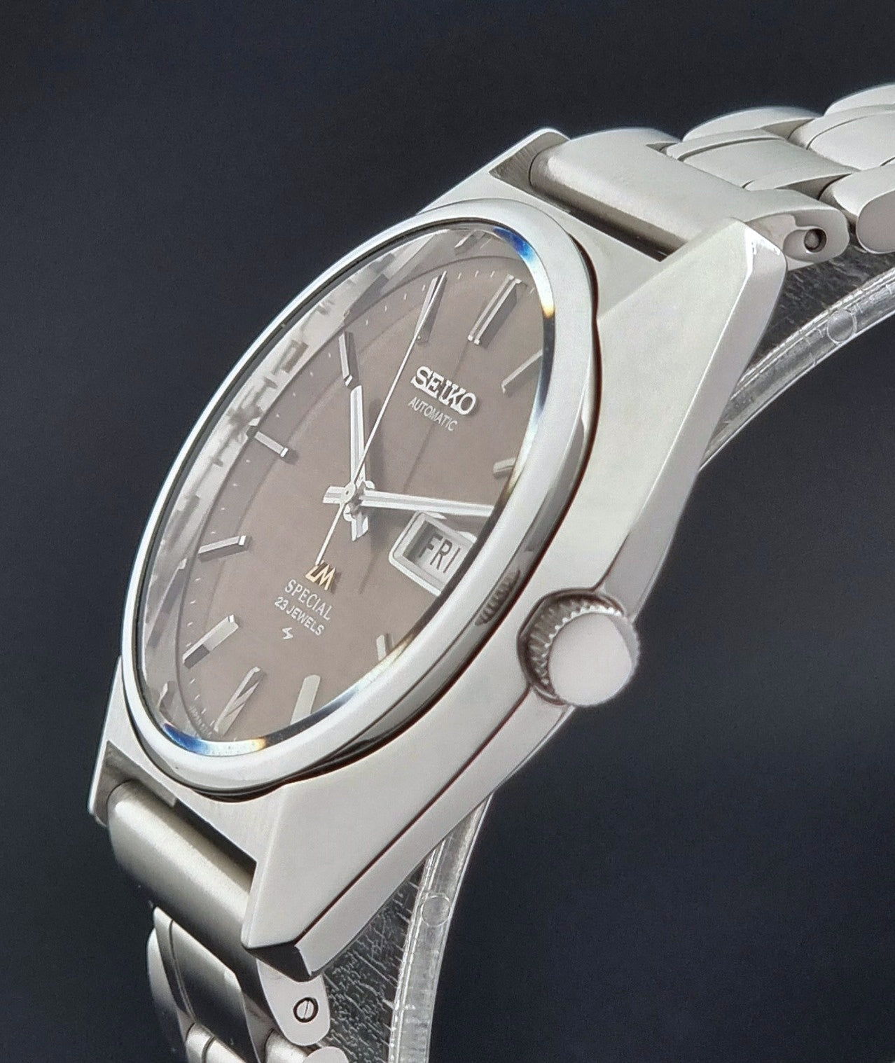 Vintage Seiko Wristwatch LordMatic Special 5216-8020 with a brown dial on a dark gray background crown profile view