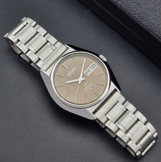 Vintage Seiko Wristwatch LordMatic Special 5216-8020 with a brown dial on a dark gray background dial