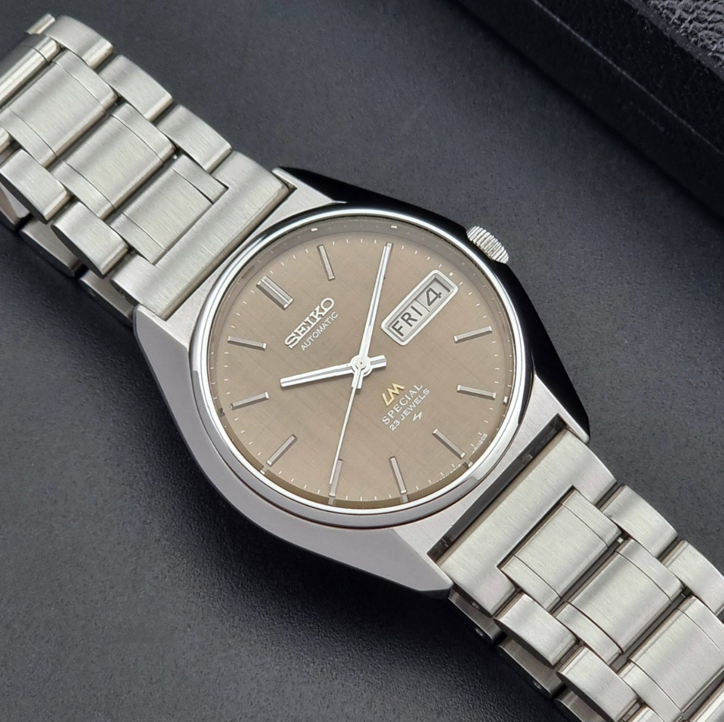 Vintage Seiko Wristwatch LordMatic Special 5216-8020 with a brown dial on a dark gray background close up dial view