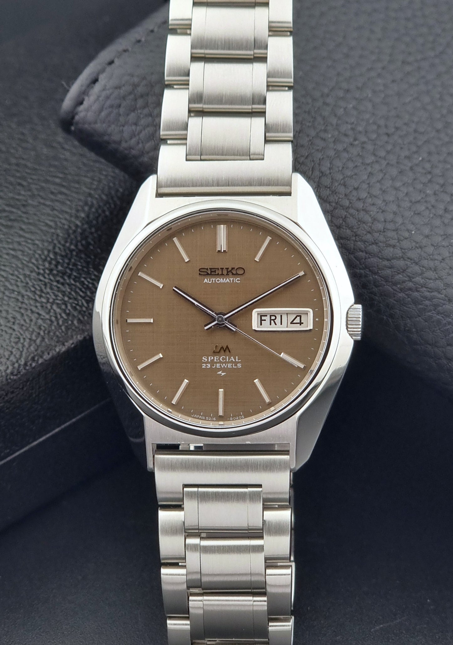 Vintage Seiko Wristwatch LordMatic Special 5216-8020 with a brown dial on a dark gray background dial view