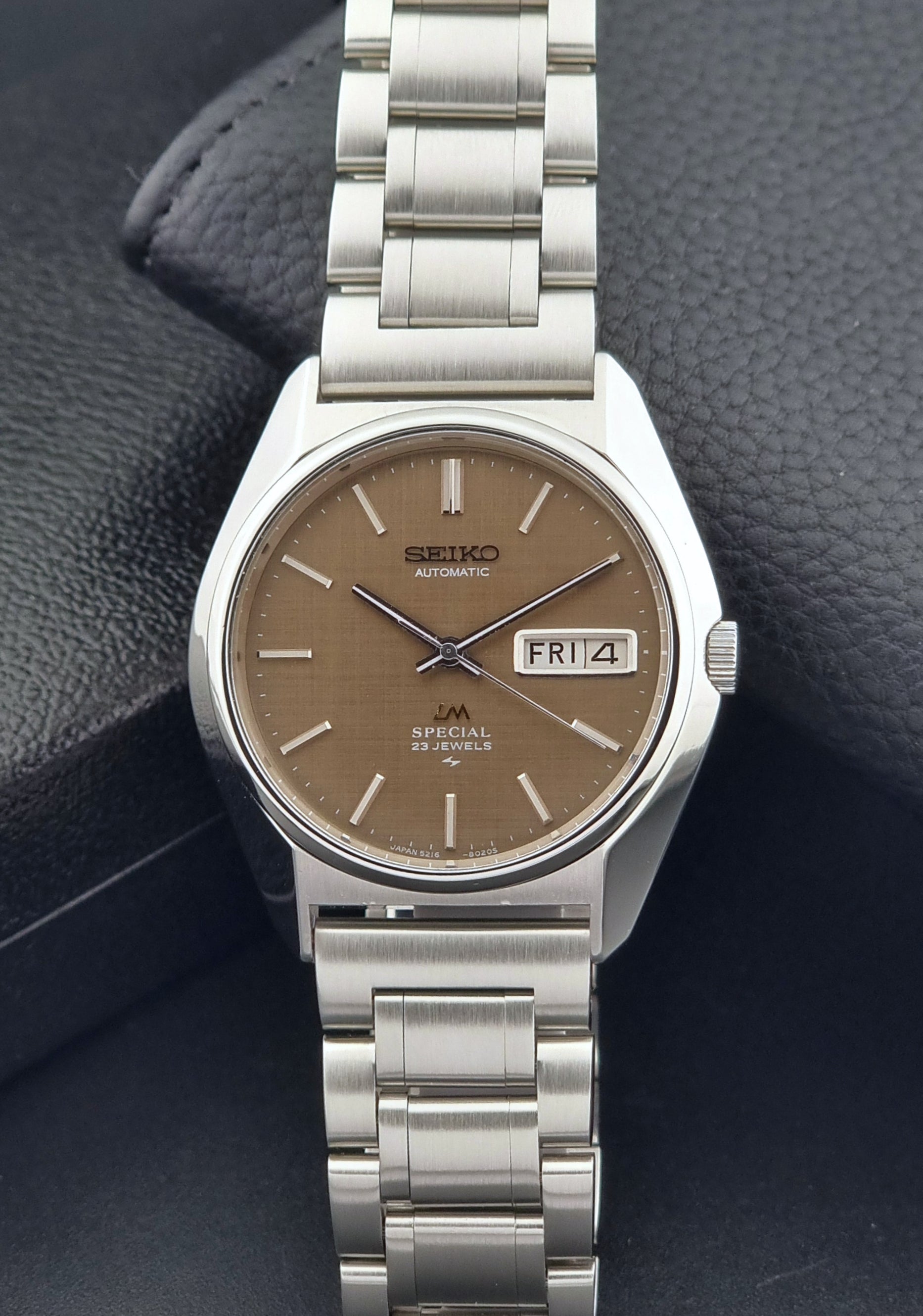 Vintage Seiko Wristwatch LordMatic Special 5216-8020 with a brown dial on a dark gray background dial view
