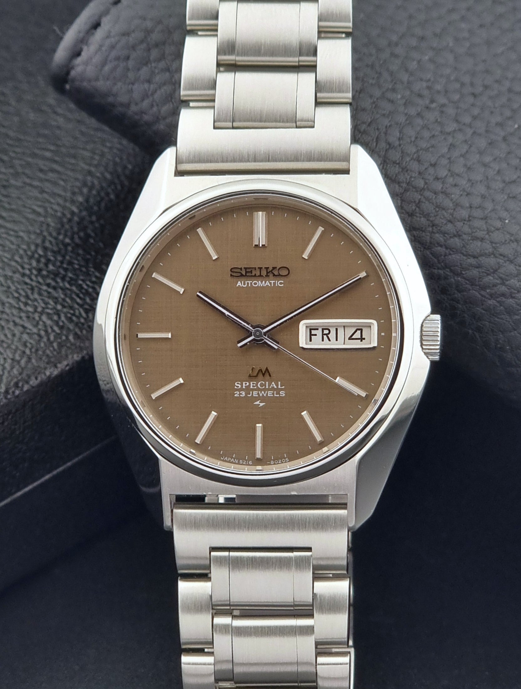 Vintage Seiko Wristwatch LordMatic Special 5216-8020 with a brown dial on a dark gray background front dial view