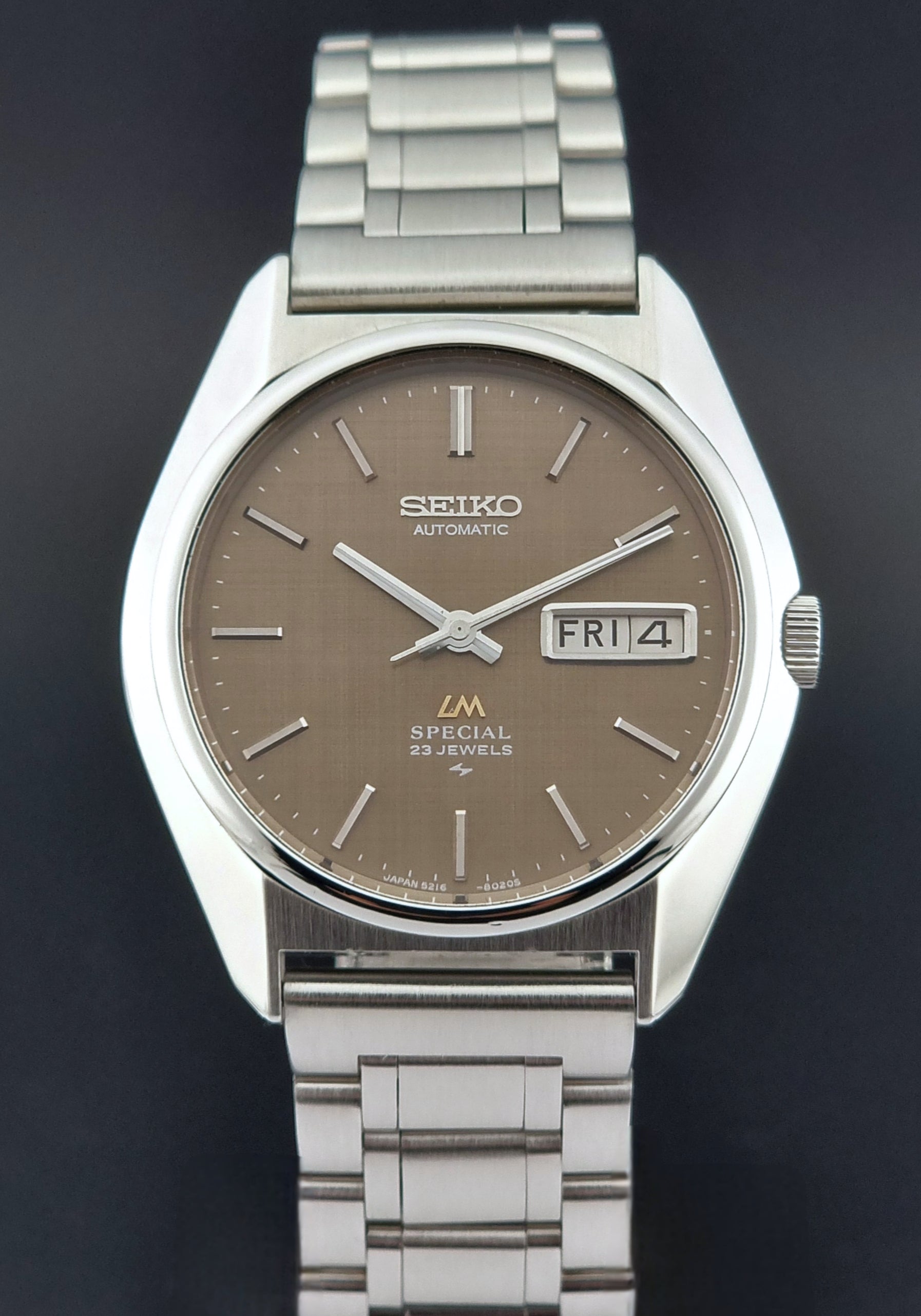 Vintage Seiko Wristwatch LordMatic Special 5216-8020 with a brown dial on a dark gray background close dial view