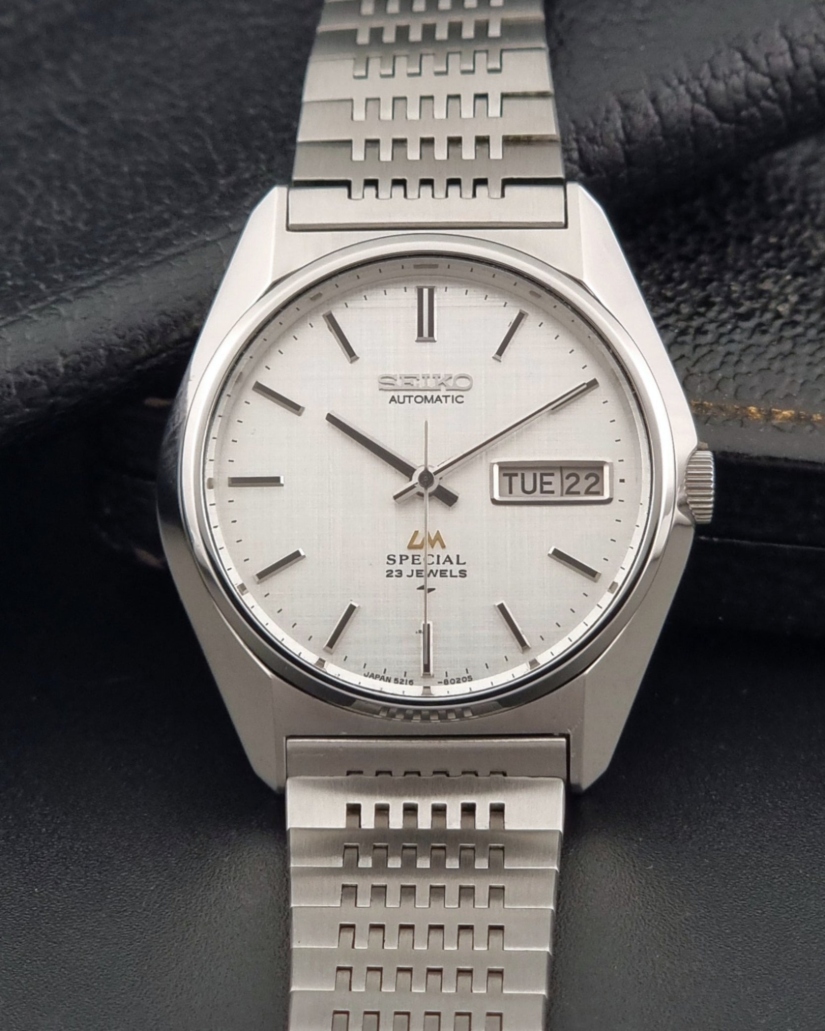 Vintage Seiko LordMatic Special 5216-8020 wristwatch wristwatch with a white face on a dark gray background front view