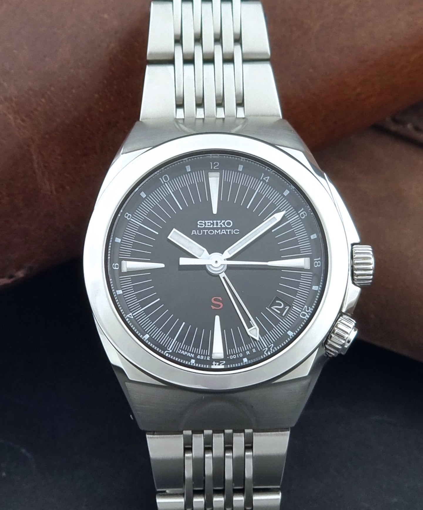 Seiko watch Mechasus SCFF005 GMT 4S12-0010 with a black dial on a gray background front view