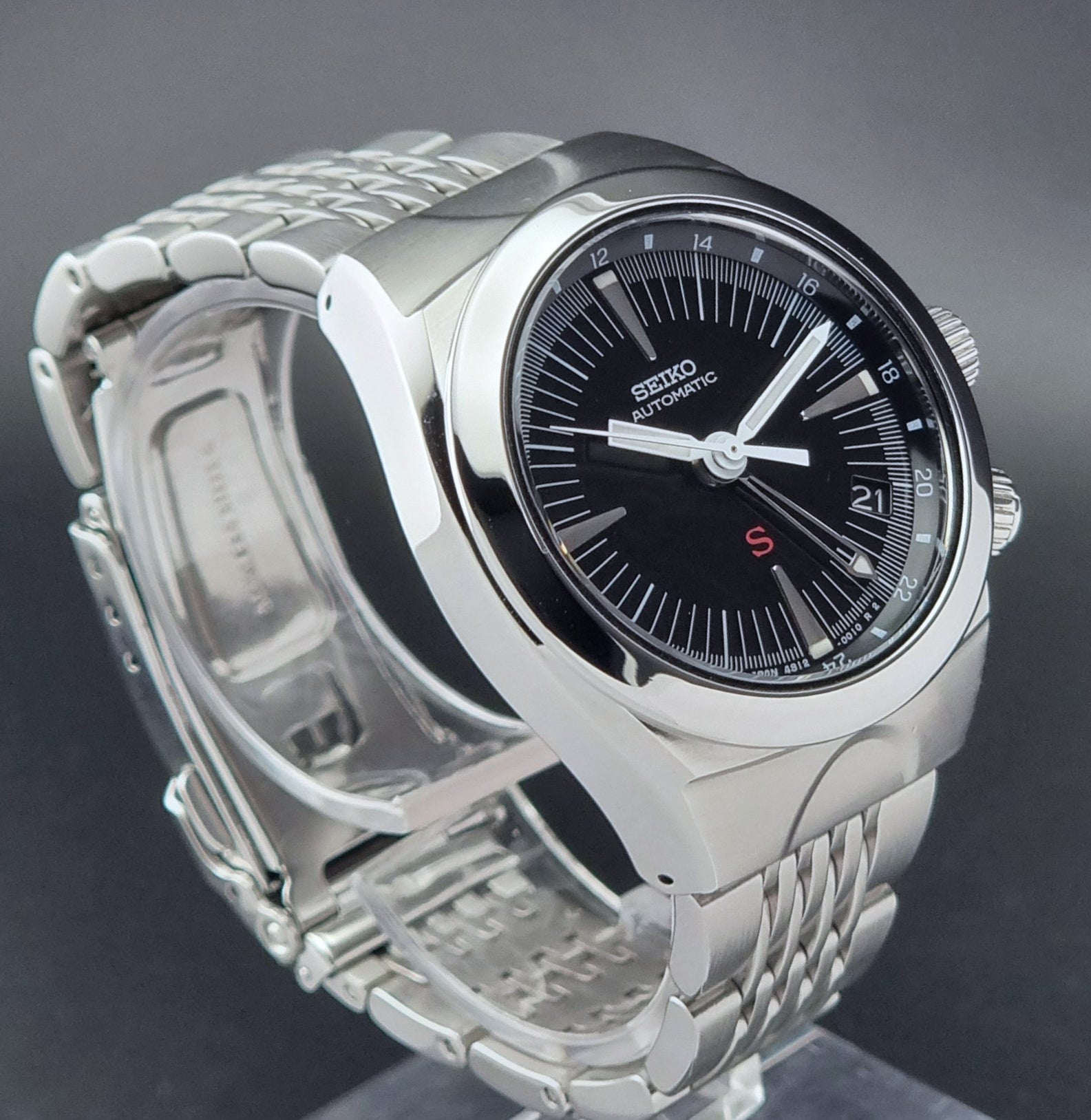 Seiko watch Mechasus SCFF005 GMT 4S12-0010 with a black dial on a gray background side profile view